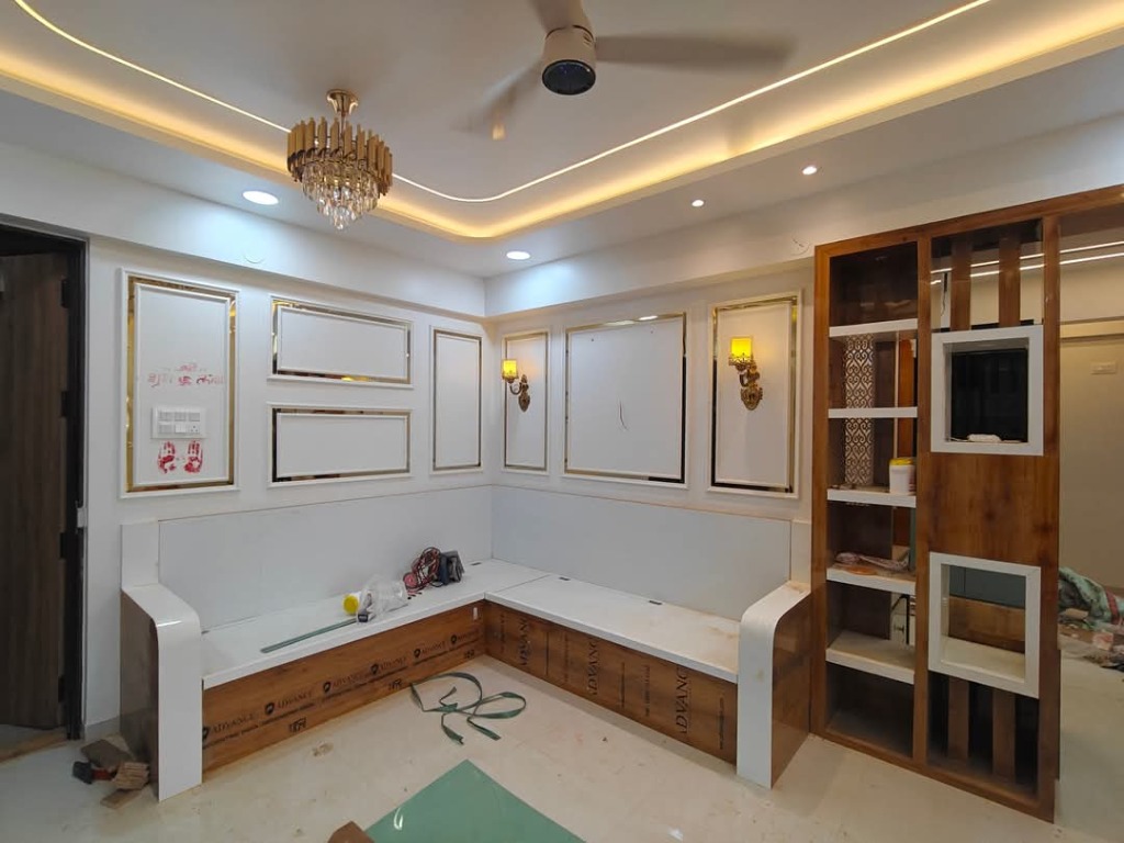 Custom on-site carpentry fabrication for storage L-sofa, foyer partition screen and wall moulding by Sharma Furniture